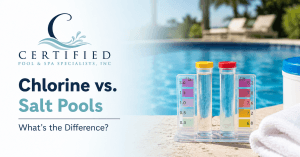 Pool water testing kit beside a swimming pool illustrating the differences between chlorine and salt pool systems.
